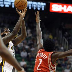 Utah Jazz power forward Marvin Williams (2) shoots over the defense of Houston Rockets point guard Patrick Beverley (2) during a game at EnergySolutions Arena on Monday, Dec. 2, 2013.