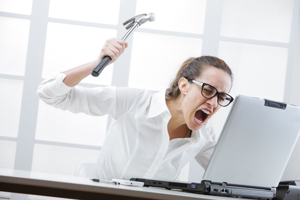 Angry woman threatens to hit laptop with hammer