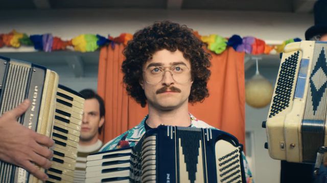 Daniel Radcliffe as Weird Al Yankovic, flanked by accordions, in a still from Weird: The Al Yankovic Story