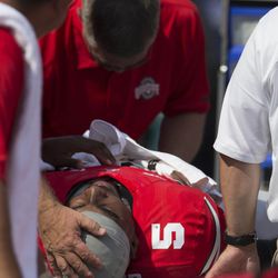 Trainers and medical staff tend to Braxton Miller after his MCL injury.