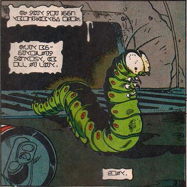 A comic book panel of a small green caterpillar character, speaking in an alien language.
