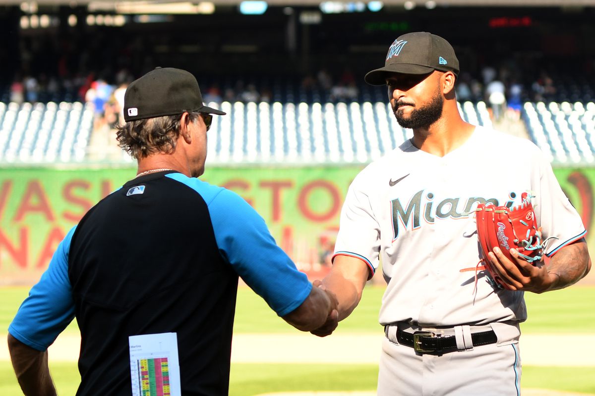 Sandy Alcantara #22 of the Miami Marlins celebrates a win with manager Don Mattingly #8 a baseball game against the Washington Nationals at Nationals Park on September 18, 2022 in Washington, DC.