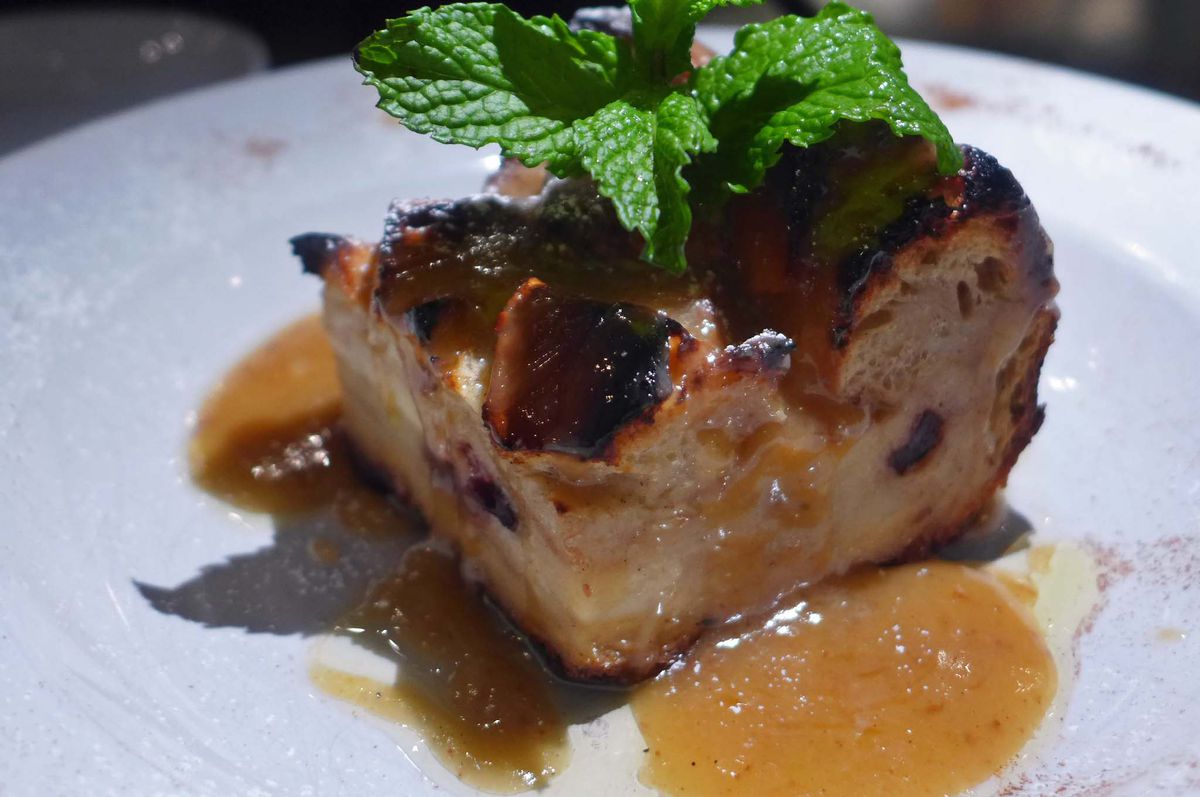 A hunk of bread pudding in sauce.