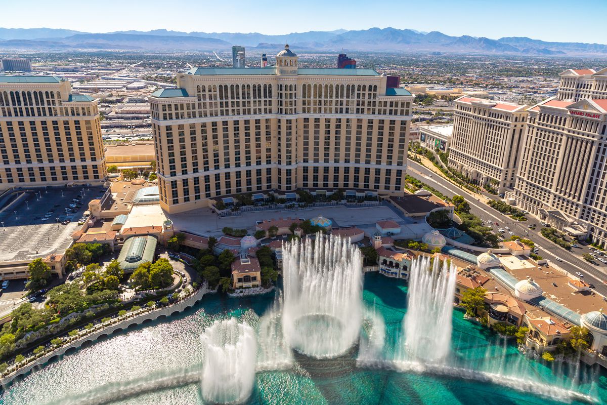An overhead view of a hotel with fountains in front
