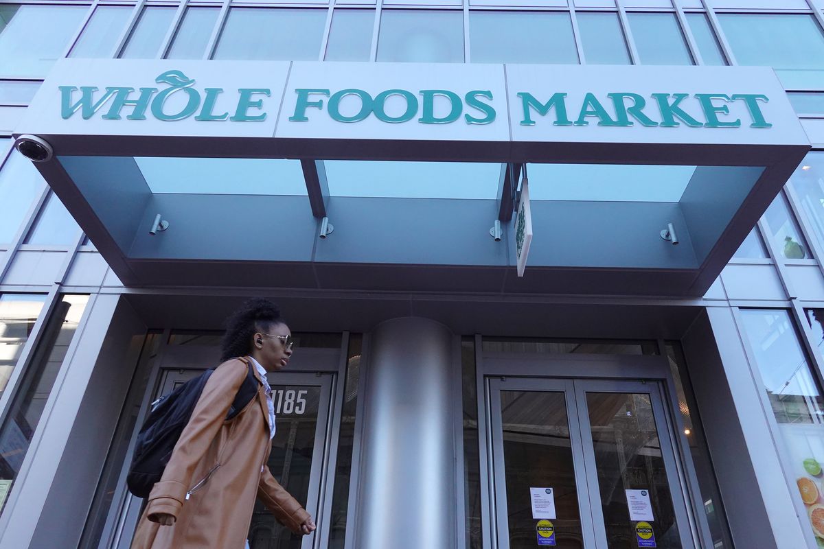 A pedestrian walks by a closed Whole Foods store in San Francisco, California.