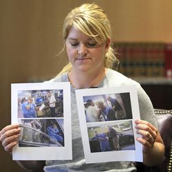 In this Friday, Sept. 1, 2017, photo, nurse Alex Wubbels displays video frame grabs from SaltLake City Police Department body cams of herself being taken into custody, during an interview, in Salt Lake City. Officials at University of Utah Hospital where Wubbels was arrested after refusing to allow police to draw a patient's blood are apologizing that security officers didn't intervene and saying they've implemented policy changes. (AP Photo/Rick Bowmer)