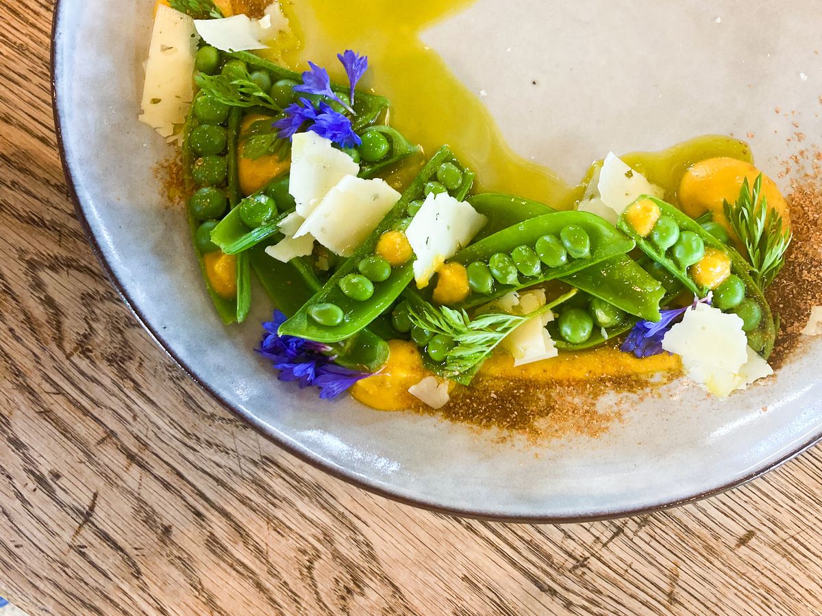 Peas, carrot puree, and flowers sit in a pool of Mineral Springs Ranch olive oil at Soter Vineyards.