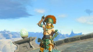 Link стои гордо носене на зонаитната броня, докато сочи нагоре в Zelda: Tears of the Kingdom