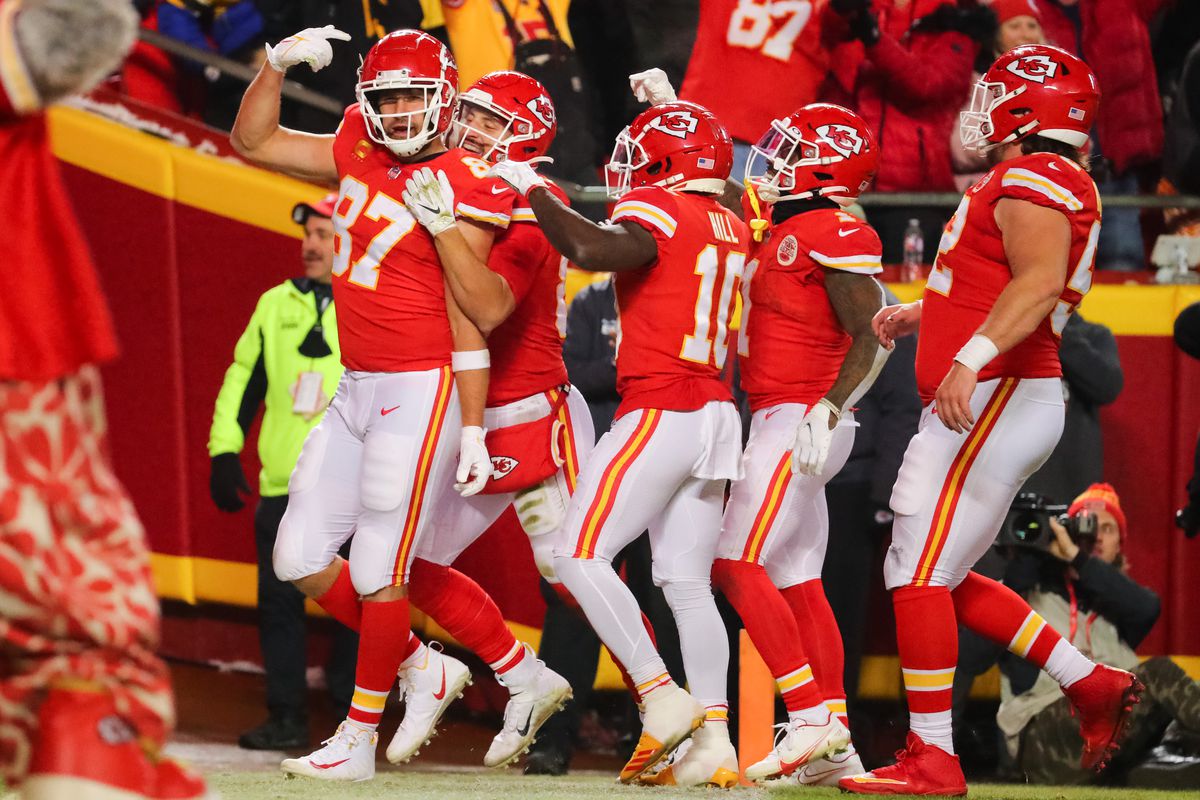 Travis Kelce #87 of the Kansas City Chiefs celebrates scoring a touchdown with teammates in the second quarter of the game against the Pittsburgh Steelers in the NFC Wild Card Playoff game at Arrowhead Stadium on January 16, 2022 in Kansas City, Missouri.
