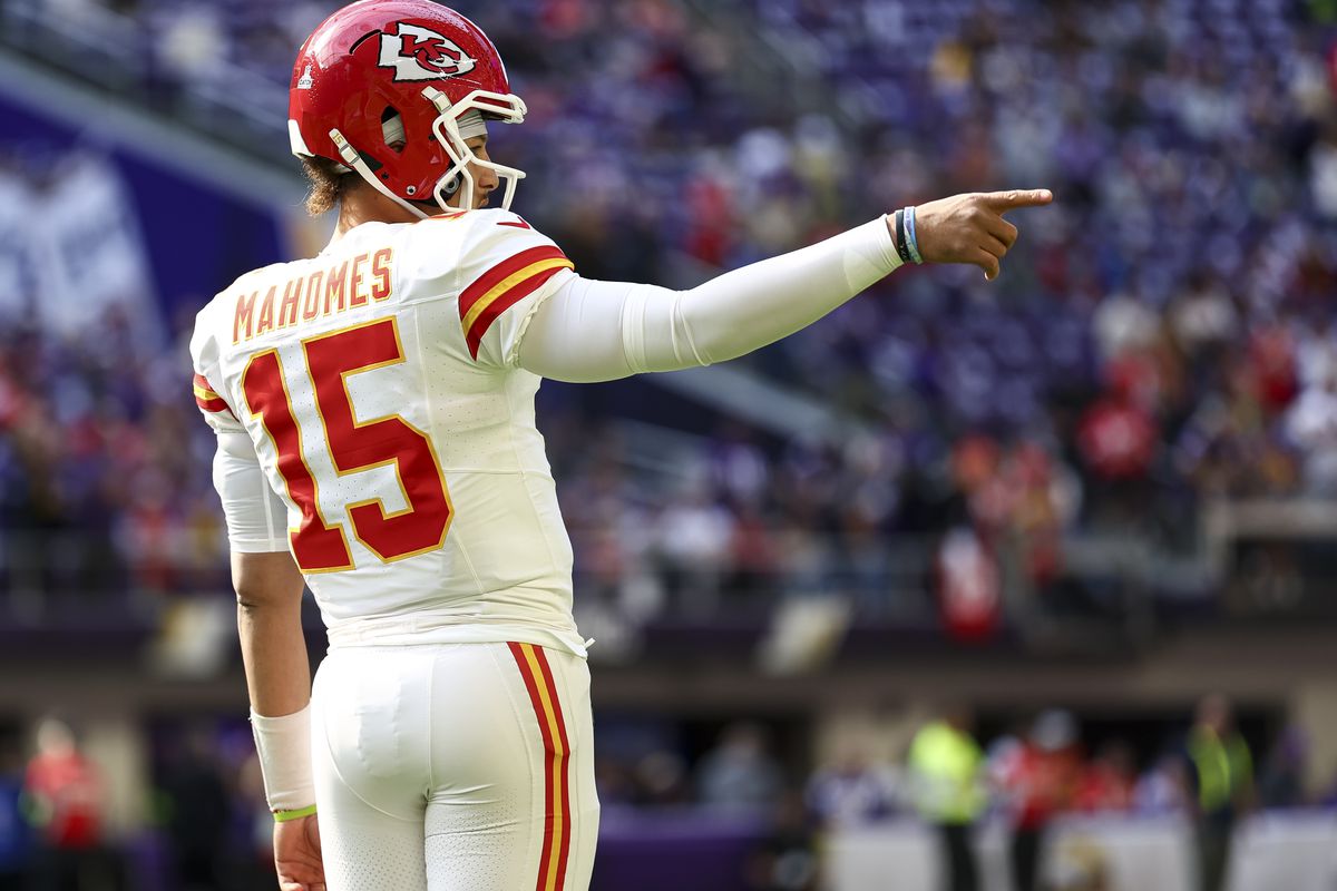 Patrick Mahomes #15 of the Kansas City Chiefs points prior to an NFL football game against the Minnesota Vikings at U.S. Bank Stadium on October 8, 2023 in Minneapolis, Minnesota.