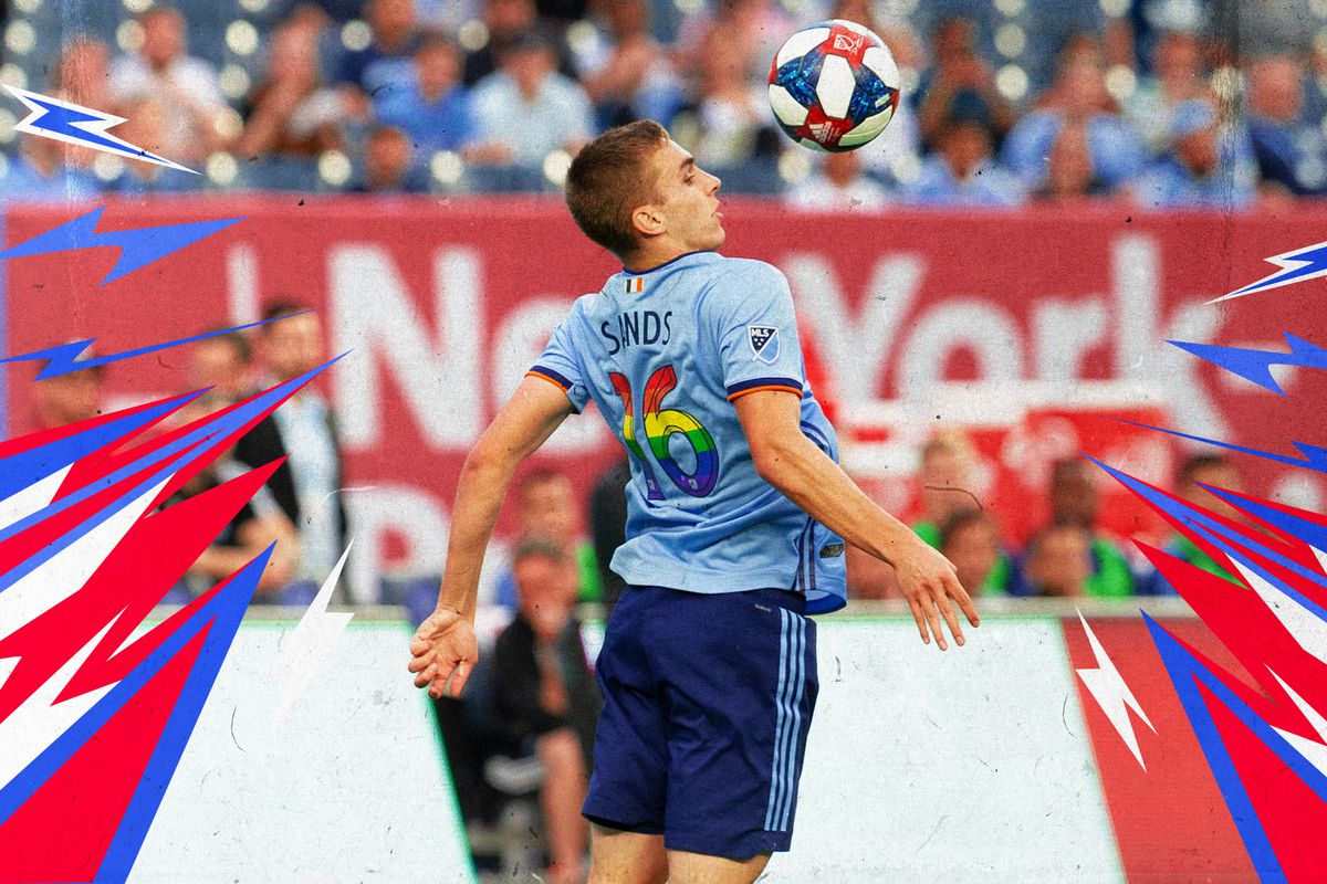NYCFC’s James Sands leaping to chest a soccer ball during a match.