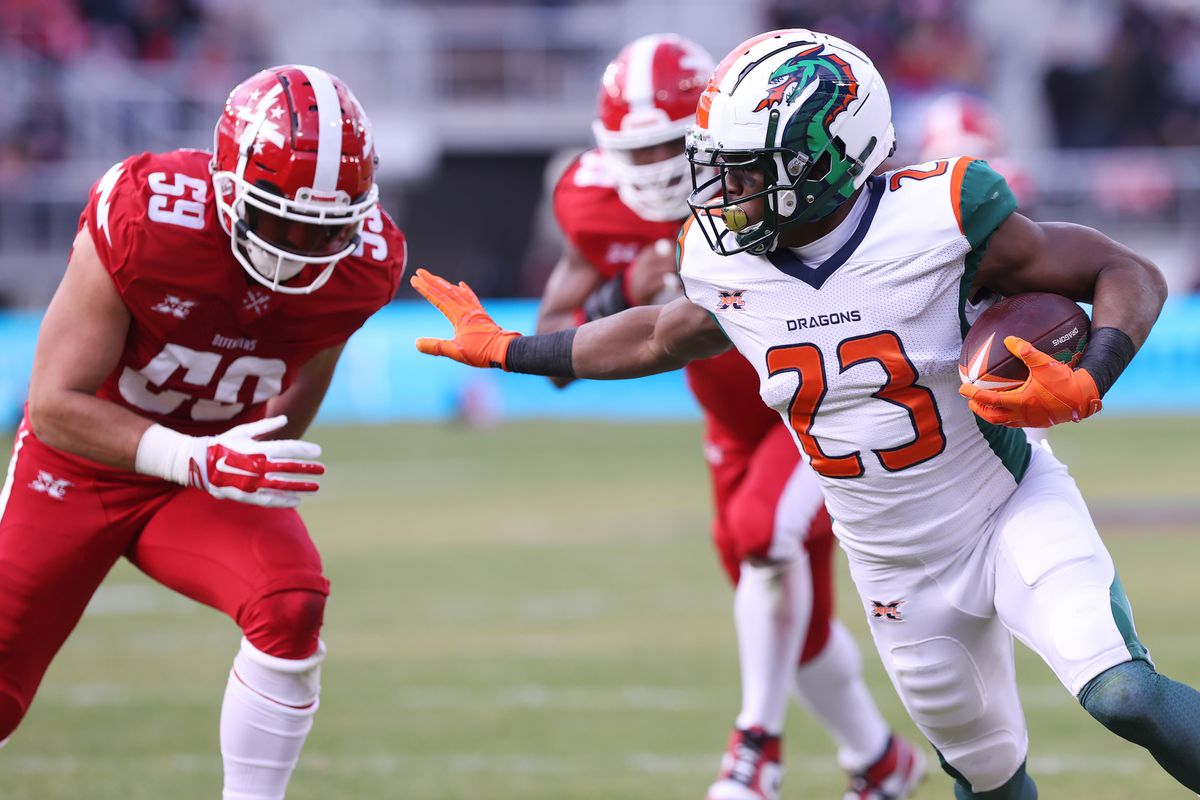 Seattle Dragons running back Trey Williams carries the ball past DC Defenders linebacker A.J. Tarpley en route to a touchdown in the second quarter during a XFL football game at Audi Field.