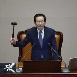 South Korea's Assembly Speaker Chung Sye-kyun presides over a plenary session to vote on the impeachment bill of South Korean President Park Geun-hye at the National Assembly in Seoul Friday, Dec. 9, 2016. South Korean lawmakers on Friday impeached Park, a stunning and swift fall for the country"™s first female leader amid protests that drew millions into the streets in united fury.