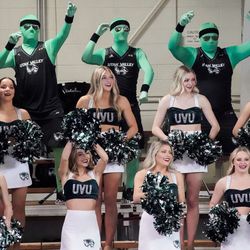 UVU cheerleaders cheer as they compete against Utah in an NCAA volleyball game at Smith Fieldhouse in Provo on Friday, Dec. 3, 2021.
