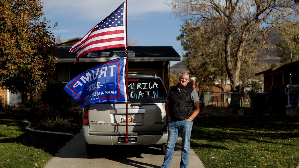 Brian Owens poses next to his SUV, on which he flies a Trump flag and an American flag, outside his home in Brigham City on Tuesday, Oct. 27, 2020.