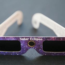A pair of solar eclipse glasses is displayed at the John A. Moran Eye Center in Salt Lake City on Wednesday, Aug. 2, 2017. Moran Eye Center locations are giving away 1,000 free pairs of the glasses.