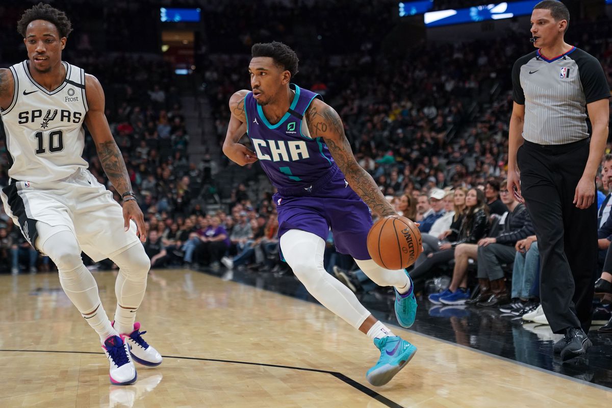 Charlotte Hornets guard Malik Monk drives past San Antonio Spurs forward DeMar DeRozan in the second half at the AT&amp;T Center.