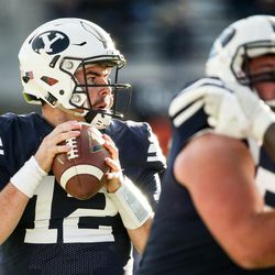 Brigham Young Cougars quarterback Tanner Mangum (12) lines up a touchdown pass to wide receiver Garrett Juergens (23), making the score 48-9 after the PAT, during a game against the UMass Minutemen at LaVell Edwards Stadium in Provo on Saturday, Nov. 19, 2016.