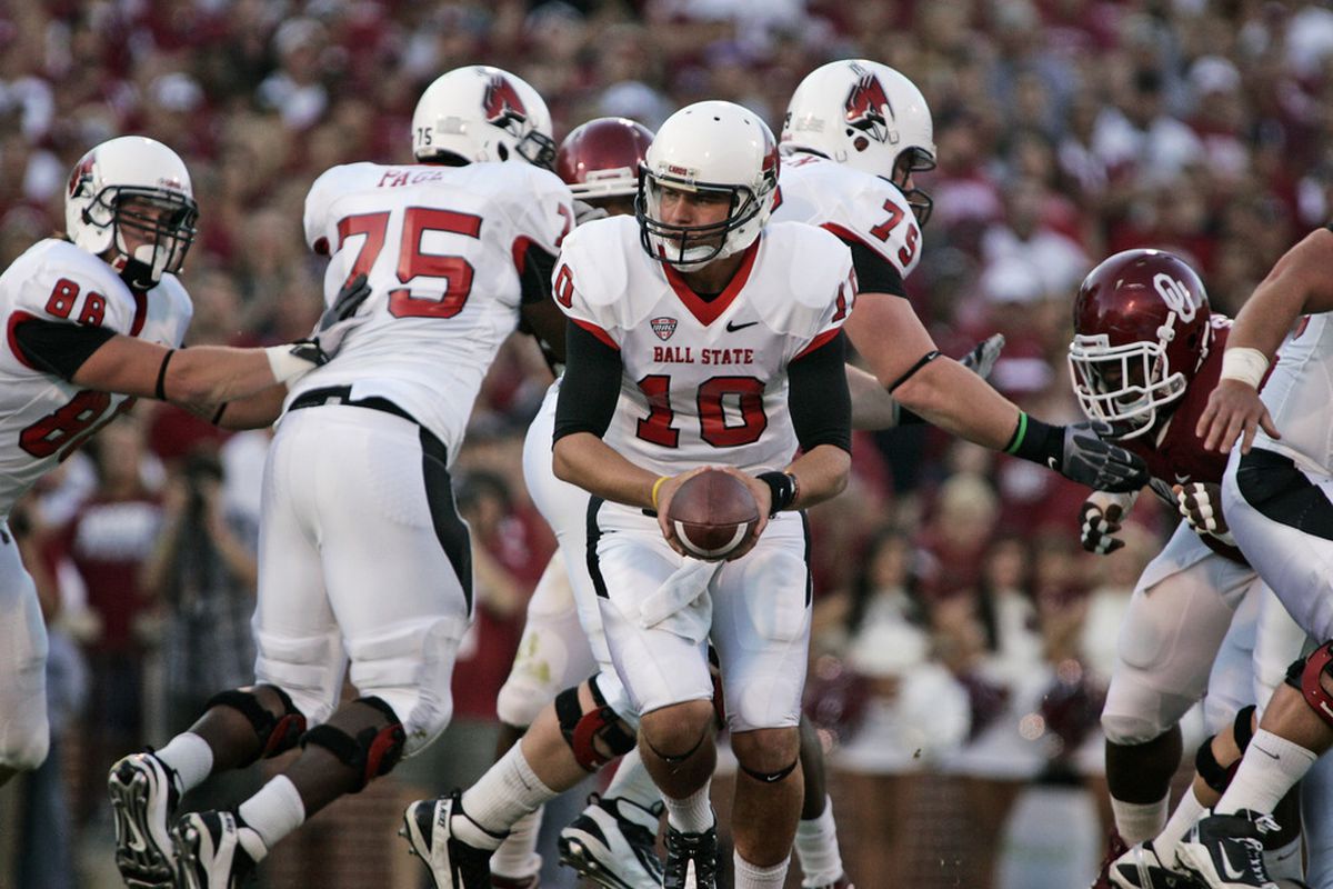 Quarterback Keith Wenning hands off in the first half against the Oklahoma Sooners.