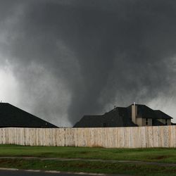 A tornado moves past homes in Moore, Okla. on Monday, May 20, 2013. 