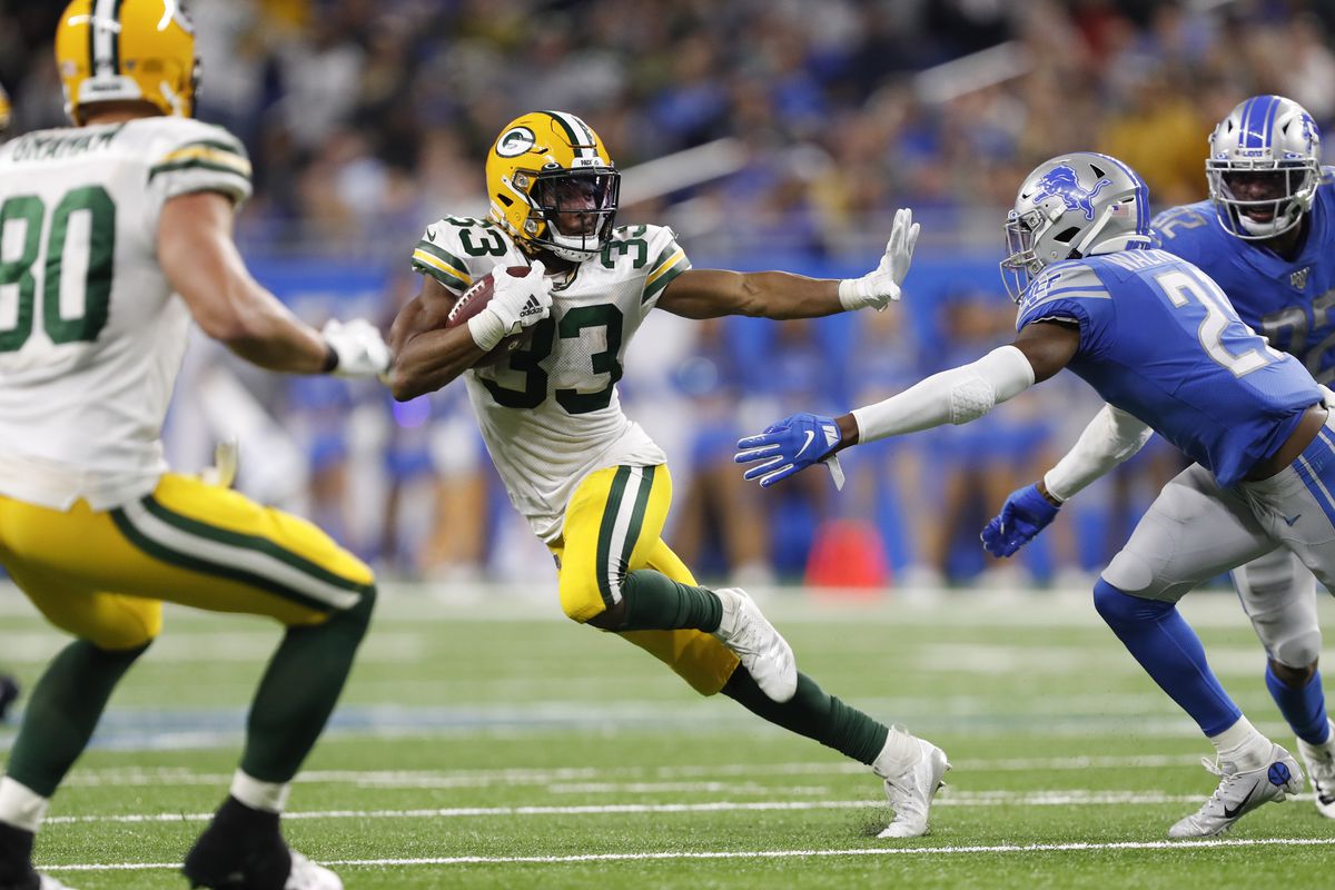 Green Bay Packers running back Aaron Jones prepares to stiff arm Detroit Lions free safety Tracy Walker during the fourth quarter at Ford Field.