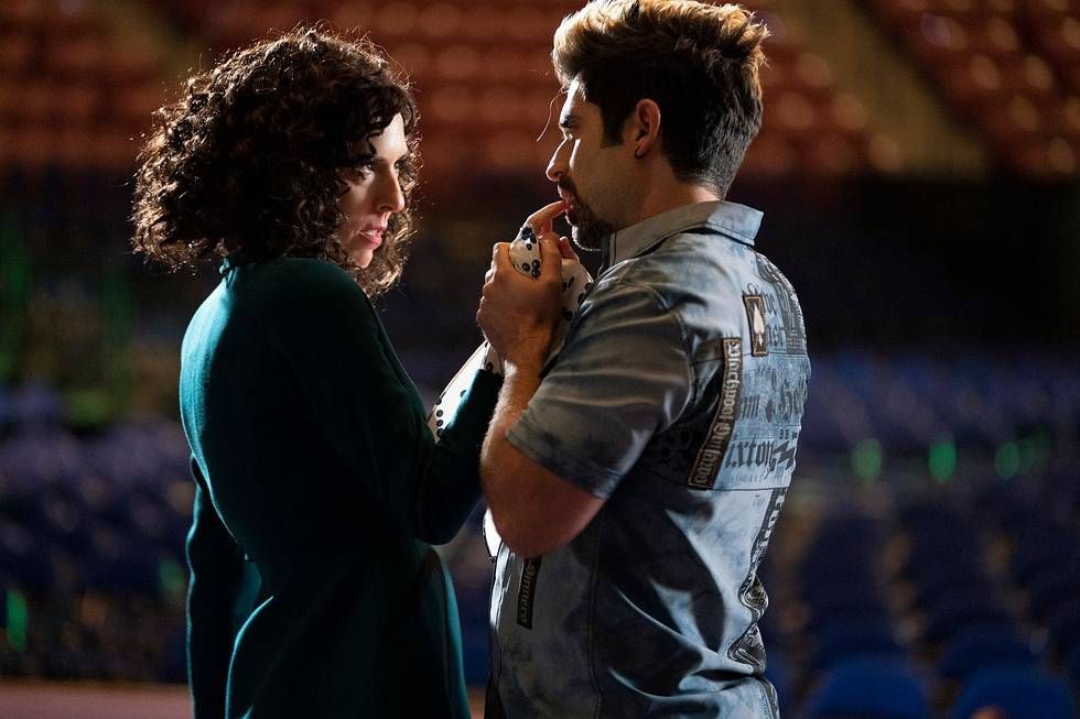 Judy Gemstone seductively sticks a finger in Stephen’s mouth on stage in an empty arena in season 3 of The Righteous Gemstones