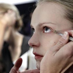 Models have make-up applied backstage before the fall 2010 collection of BCBGMAXAZRIA is presented during Mercedes-Benz Fashion Week, in New York,  Thursday, Feb. 11, 2010. 