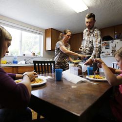 Riley Anderson and his wife, Hanna, set out supper for their daughters in Orderville, Kane County, Thursday, Aug. 20, 2015.