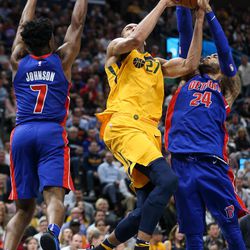 Utah Jazz center Rudy Gobert (27) meets resistance at the hoop from Detroit Pistons forward Stanley Johnson (7) and forward Eric Moreland (24) at Vivint Smart Home Arena in Salt Lake City on Tuesday, March 13, 2018.