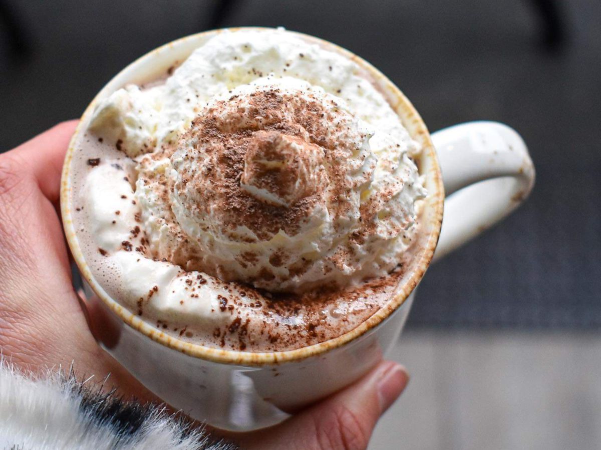 A boozy hot chocolate topped with a huge dollop of whipped cream 