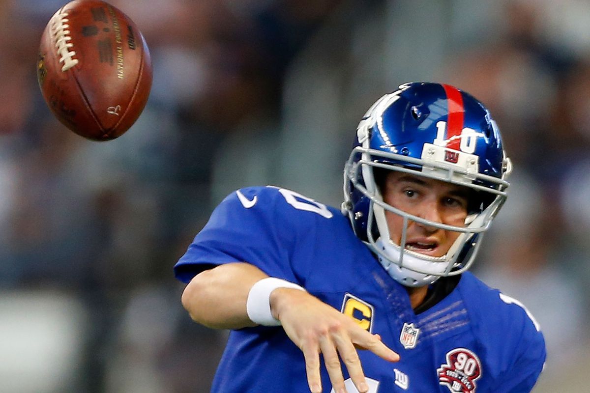 Eli Manning spikes a pass against the Dallas Cowboys