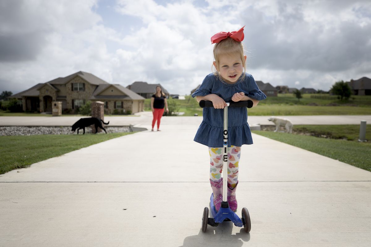 Lily Clark, 3, plays outside her home in Aledo, Texas.
