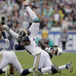 Miami Dolphins running back Jay Ajayi, right, is tackled by Los Angeles Rams free safety Maurice Alexander during the the first half of an NFL football game Sunday, Nov. 20, 2016, in Los Angeles. (AP Photo/Jae C. Hong)