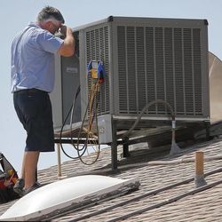 Parker & Sons Air Conditioning warranty supervisor Michael Hawks wipes his brow while inspecting an a/c unit, Friday, June 28, 2013 in Phoenix. Excessive heat warnings will continue for much of the Desert Southwest as building high pressure triggers major warming in eastern California, Nevada, and Arizona. Dangerously hot temperatures are expected across the Arizona deserts throughout the week with a high of 118 Friday. (AP Photo/Matt York)