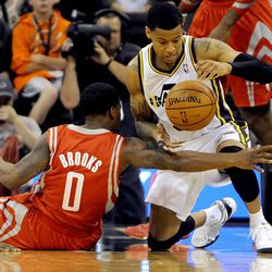 Utah Jazz point guard Trey Burke (3) grabs a loose ball from Houston Rockets point guard Aaron Brooks (0) during a game at EnergySolutions Arena on Monday, December 2, 2013.