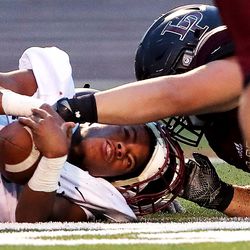 Herriman's Miles Jefferson recovers his fumble on a kickoff return as the Mustangs and Lone Peak play at Lone Peak on Friday, Aug. 17, 2018.