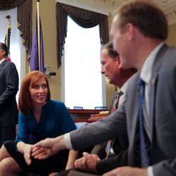 While Sen. Mitt Romney, R-Utah, speaks honoring her late husband, Jennie Taylor, greets Rep. Chris Stewart, R-Utah, and Rep. Ben McAdams, D-Utah, right, during a reception given by Rep. Rob Bishop, R-Utah on Capitol Hill in Washington, D.C., on Feb. 6, 2019. Taylor is the widow of former North Ogden mayor and major in the U.S. Army National Guard Brent Taylor who was killed in Afghanistan in November 2018.