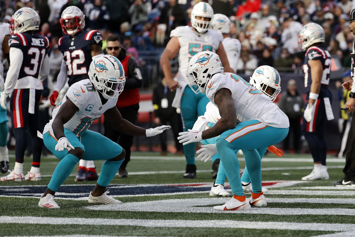 Miami Dolphins running back Raheem Mostert (31) celebrates his touchdown with Miami Dolphins wide receiver Tyreek Hill (10) during a game between the New England Patriots and the Miami Dolphins on January 1, 2023, at Gillette Stadium in Foxboro, Massachusetts.