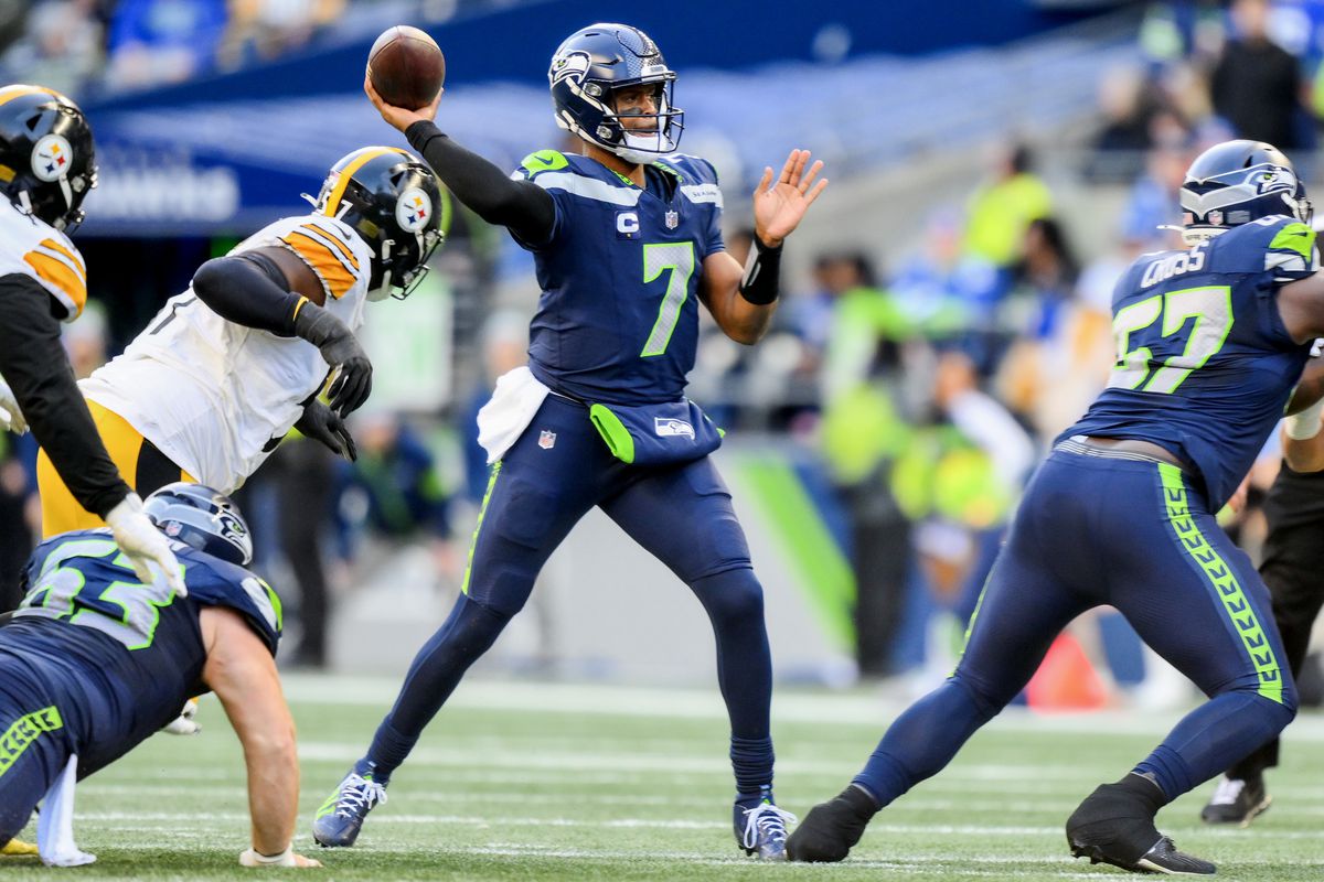 Geno Smith of the Seattle Seahawks throws a pass for a first down during the second quarter of a game against the Pittsburgh Steelers at Lumen Field on December 31, 2023 in Seattle, Washington.