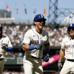 SEATTLE, WASHINGTON - AUGUST 28: Dylan Moore #25 of the Seattle Mariners celebrates his three-run home run against the Cleveland Guardians during the fifth inning at T-Mobile Park on August 28, 2022 in Seattle, Washington.