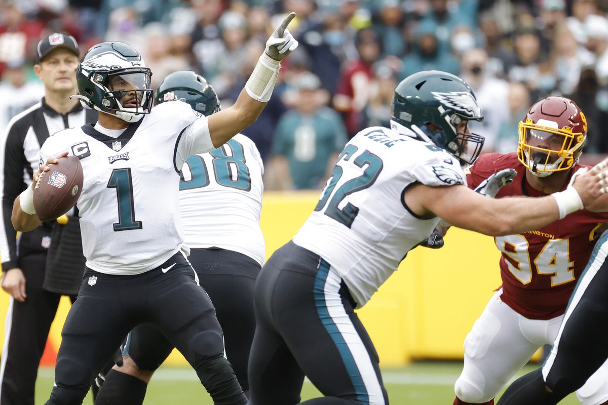Philadelphia Eagles quarterback Jalen Hurts (1) gestures downfield while preparing to pass the ball as Washington Football Team defensive tackle Daron Payne (94) chases during the third quarter at FedExField.