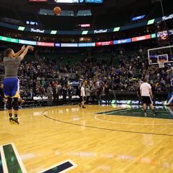Golden State Warriors guard Stephen Curry practices shooting from the center circle before an NBA regular season game against the Utah Jazz at the Vivint Arena in Salt Lake City, Wednesday, March 30, 2016.