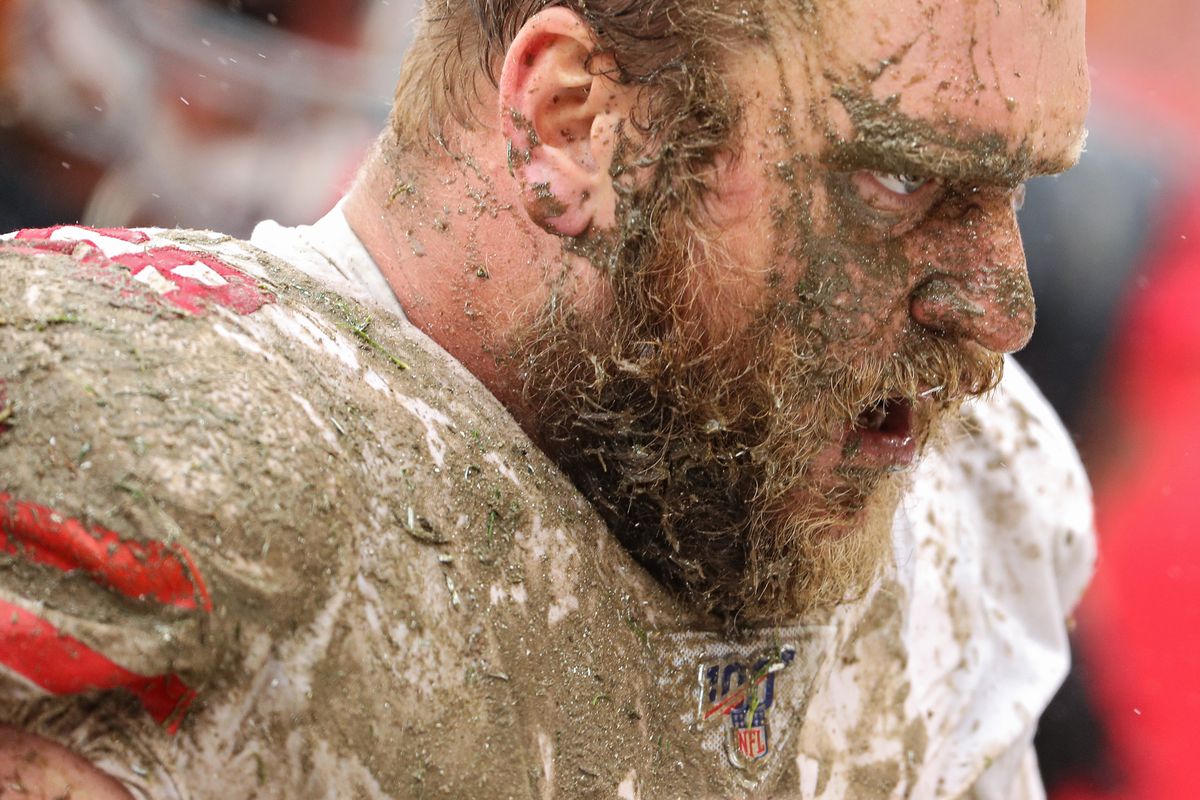 Covered in mud, offensive guard Mike Person #68 of the San Francisco 49ers looks on after making a tackle during the third quarter at FedExField on October 20, 2019 in Landover, Maryland.