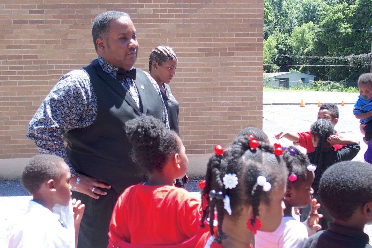 Principal Antonio Harvey watches after kindergarteners in a 2017 graduation ceremony at Hawkins Mill Elementary School in Memphis.
