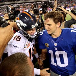Manning shares a moment with big brother Peyton after a Week 2 loss to the Denver Broncos