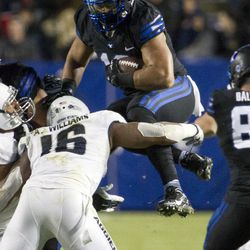 Brigham Young linebacker Harvey Langi (16) hurdles Utah State linebacker Anthony Williams (16) during an NCAA college football game in Provo on Saturday, Nov. 27, 2016. Brigham Young defeated in-state foe Utah State 28-10.