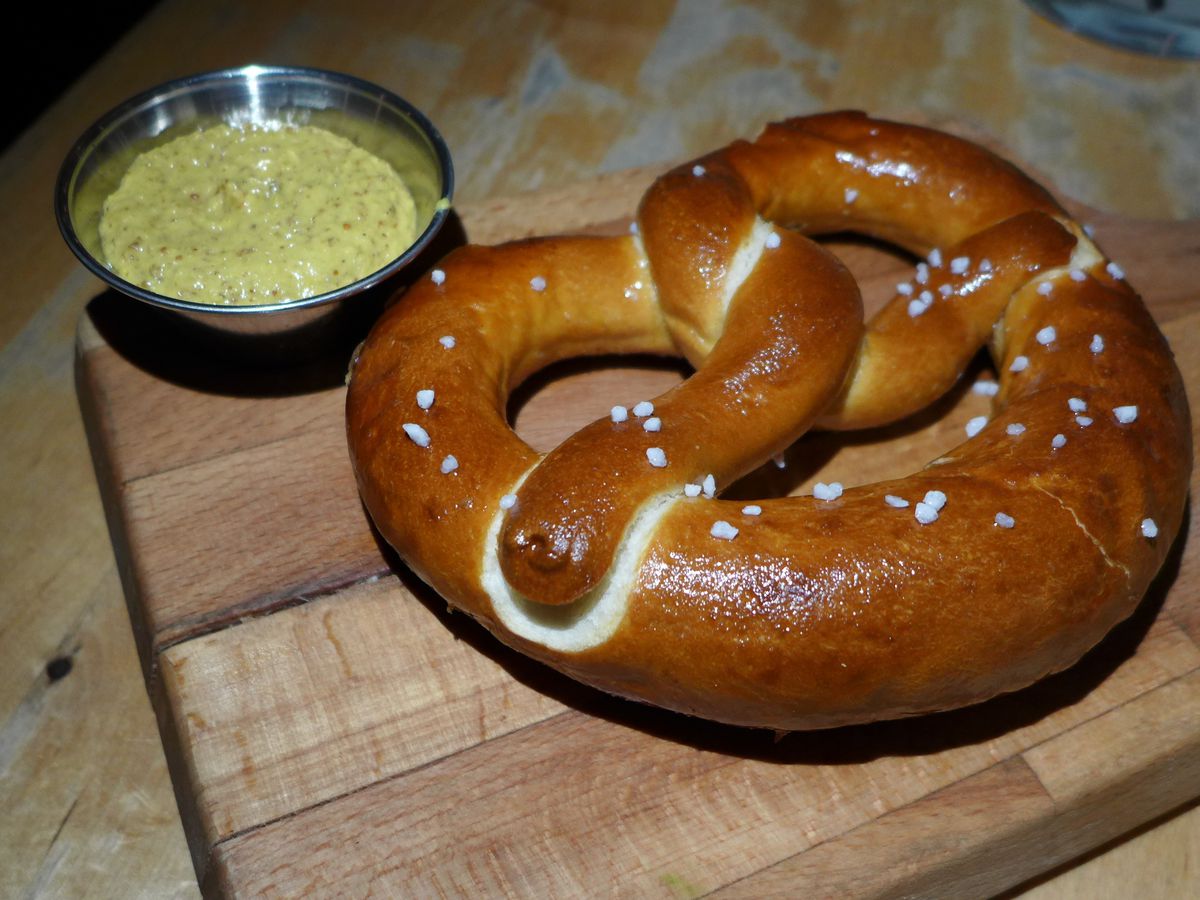 A big pretzel with mustard