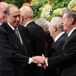 President Thomas S. Monson shakes hands with Elder Jeffrey R. Holland as he leaves the morning session of the 183rd Annual General Conference of The Church of Jesus Christ of Latter-day Saints in the Conference Center in Salt Lake City on Sunday, April 7, 2013.
