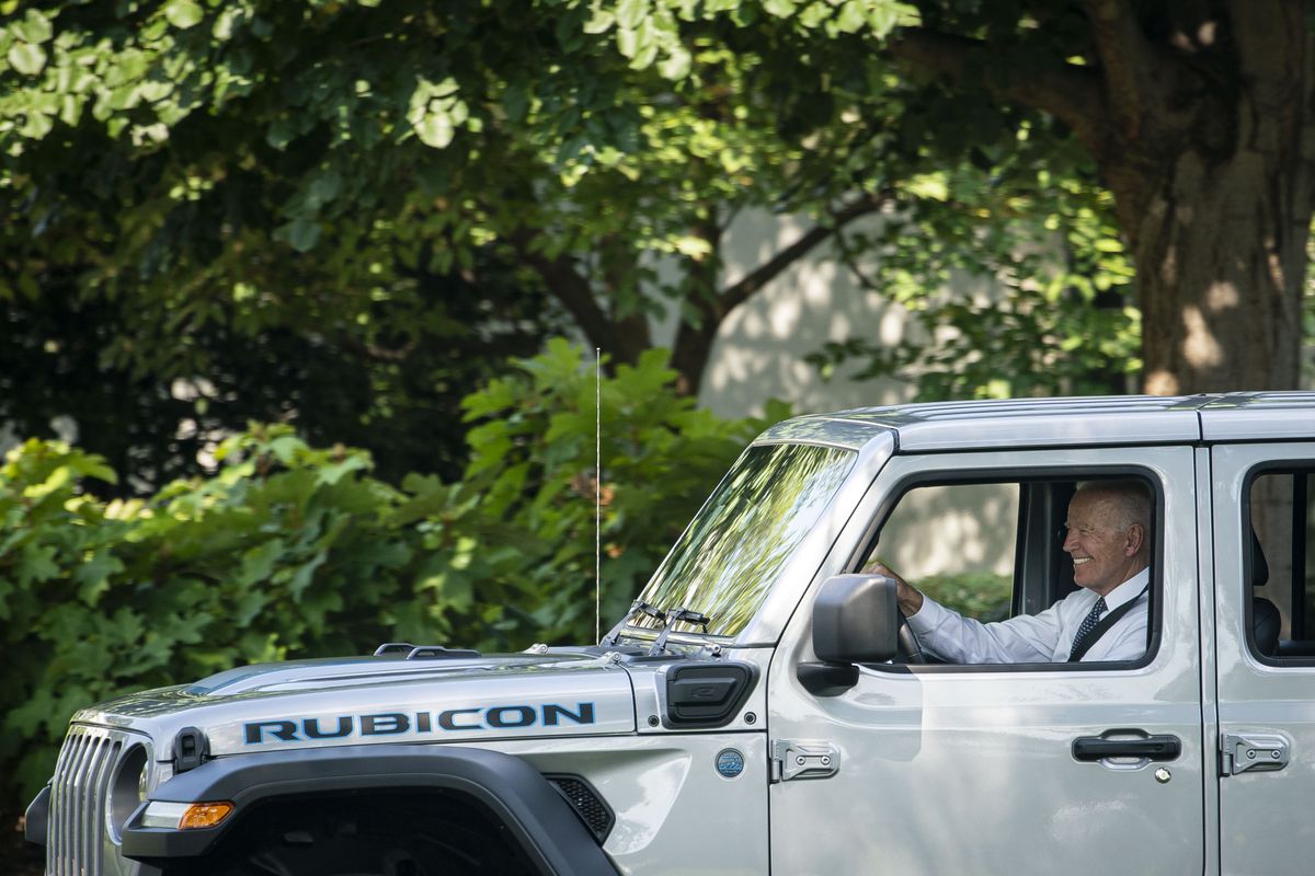 Joe Biden sitting in the driver’s seat of an electric Jeep.