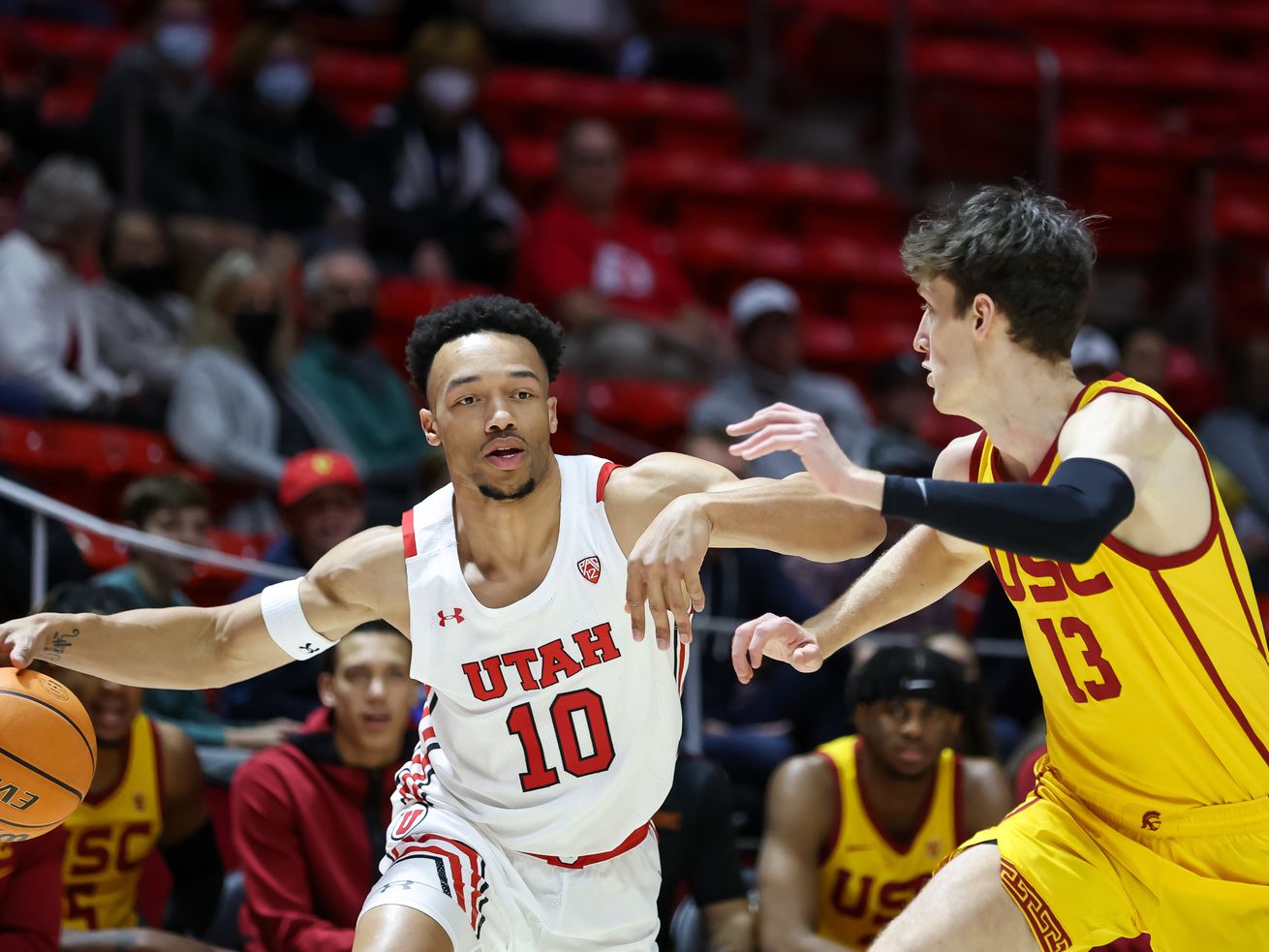 Utah Utes guard Marco Anthony (10) drives against USC Trojans guard Drew Peterson (13) during the game at the Huntsman Center in Salt Lake City on Saturday, Jan. 22, 2022.